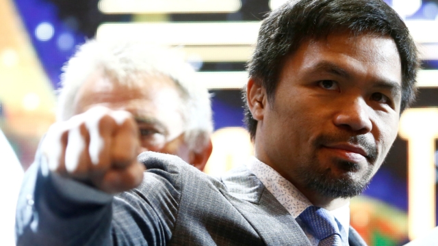 FILE PHOTO: Philippine boxing icon Manny "Pacman" Pacquiao poses for photographers during a news conference with welterweight world title holder Lucas Matthysse (not pictured), for their upcoming WBA "regular" welterweight title fight, at a hotel in Kuala Lumpur, Malaysia April 20, 2018. REUTERS/Lai Seng Sin/File Photo